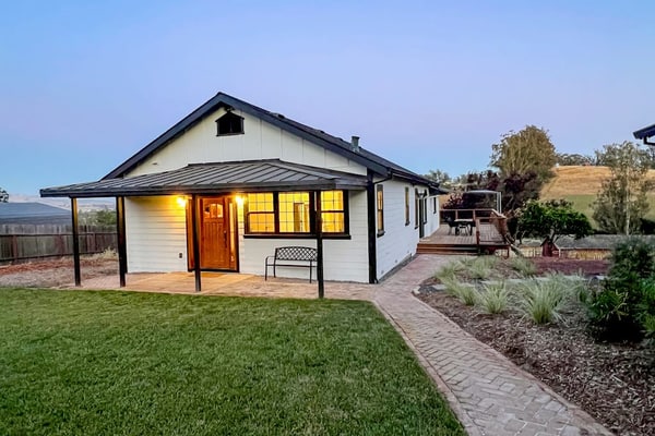 Golden hills unfold beyond the deck as you settle into this modern farmhouse on an 11-acre working ranch. A striking black-and-white palette and open floor plan give way to panoramic valley views — sheep grazing below, sunset painting the ridgeline. Penngrove puts you 10 minutes from Petaluma, 25 minutes from Sonoma Plaza, and within easy reach of every wine region in the county. Bring the dogs and let the quiet of ranch country settle in.