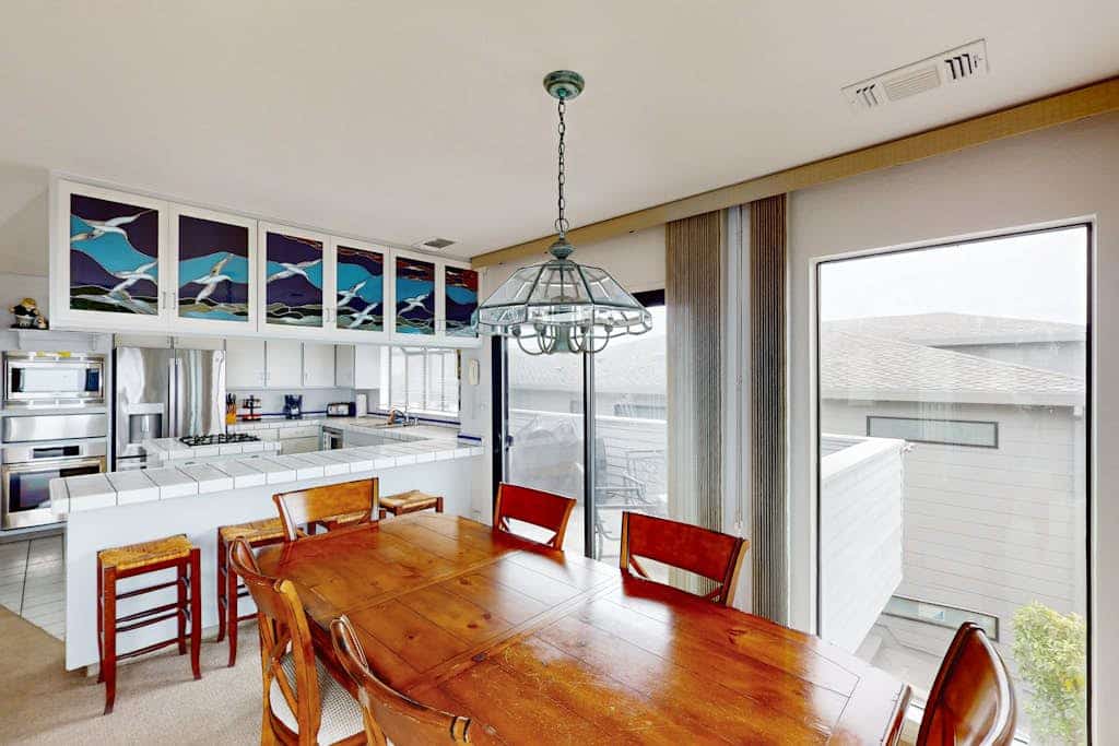Floor-to-ceiling windows frame the Pacific as you sink into plush seating by the gas fireplace. Challenge friends to pool or ping-pong in your private game room, then grill fresh seafood on the ocean-view balcony. This 3-bedroom coastal retreat sleeps 8 with two California king suites. Just 0.2 miles from Birdwalk Coastal Access Trail and 0.5 miles from Sonoma Coast Vineyards. Watch gray whales migrate past from December through May — Bodega Head's famous viewing spot is minutes away.