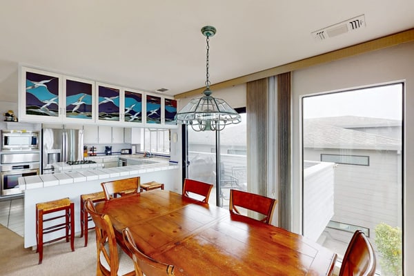 Floor-to-ceiling windows frame the Pacific as you sink into plush seating by the gas fireplace. Challenge friends to pool or ping-pong in your private game room, then grill fresh seafood on the ocean-view balcony. This 3-bedroom coastal retreat sleeps 8 with two California king suites. Just 0.2 miles from Birdwalk Coastal Access Trail and 0.5 miles from Sonoma Coast Vineyards. Watch gray whales migrate past from December through May — Bodega Head's famous viewing spot is minutes away.
