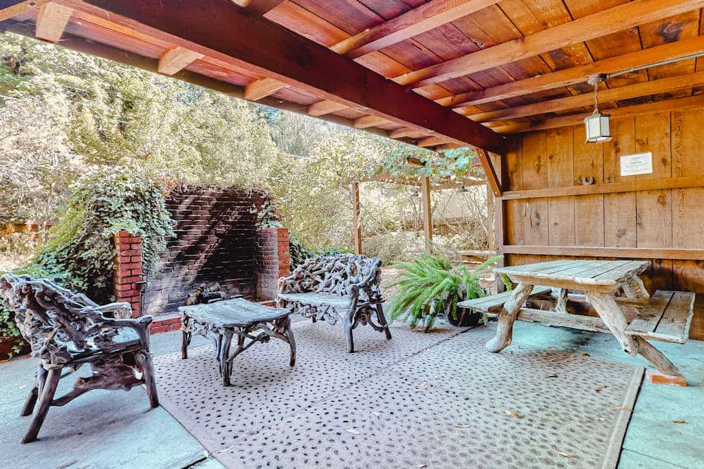 Sunlight filters through towering redwoods onto the private hot tub where you'll soak after floating the Russian River. This 1930s log lodge sleeps 10 with room for your dogs to roam the enclosed yard. Step through the 11-foot picture window view to your private river beach — one of the best fishing holes in Guerneville. Just 0.2 miles from The Lodge at Dawn Ranch and 0.3 miles from downtown's taco trucks and cafes.