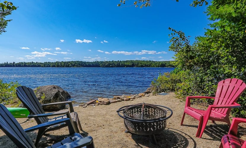 Quiet lakefront cottage with a firepit, private beach, & two kayaks