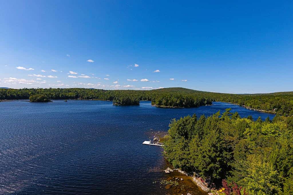 Quiet lakefront cottage with a firepit, private beach, & two kayaks