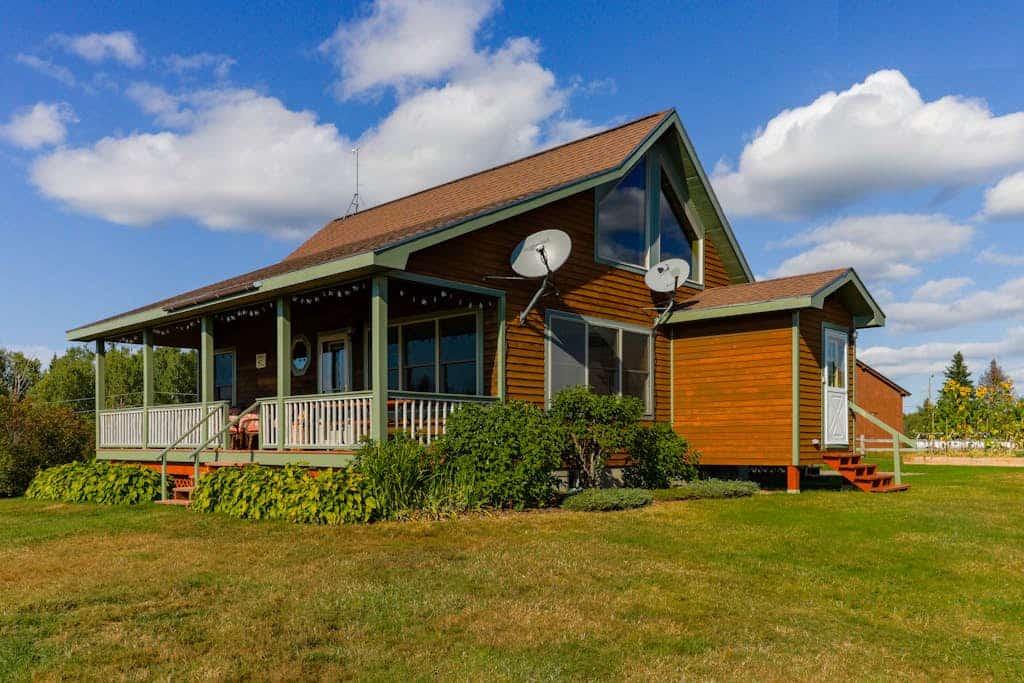 Two lakefront dog-friendly cabins on four acres with porches, dock, & lake views