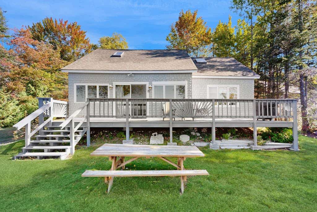 Lakefront home with private dock, mooring, pebble beach, grill, & firepit