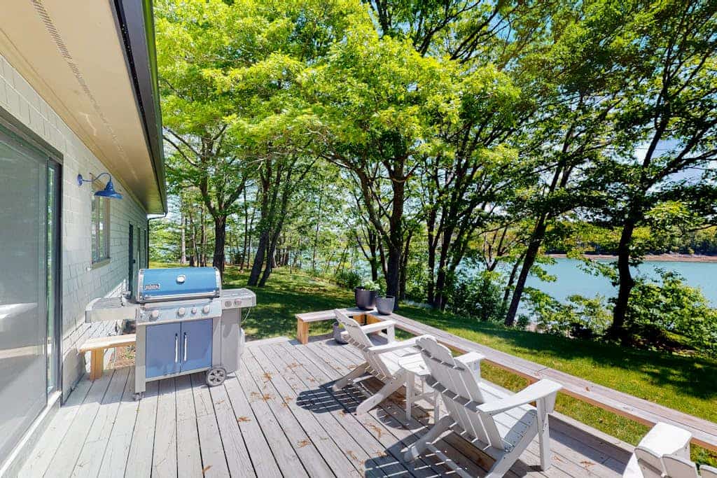 Water-view retreat with beach access, deck, grill, EV charger & lawn games