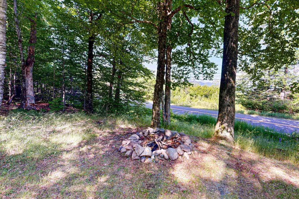 Scenic retreat with a spacious deck, gas fireplace, and glimpses of Moosehead Lake