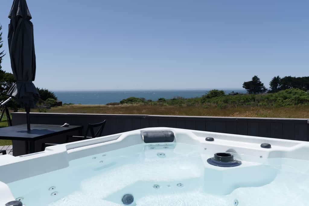 Wake to the sound of the Pacific spilling across the commons and the light shifting hour by hour over the bluff. By night, slip into the hot tub, cut the jets, and let the sea take over while the stars come out. Room for 4 in this 2-bedroom Sea Ranch home. Your recreation key unlocks heated community pools, saunas, and 50 miles of bluff and forest trails. A rhythm of fog, sun, and salt air you'll settle into by day two.