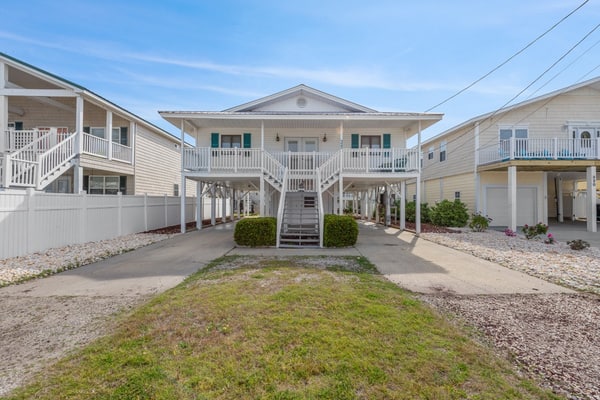 Welcome to the Blushing Mermaid, a charming three bedroom beach house located right on the inlet and just a short walk from the sand in Cherry Grove. Designed for comfort, connection, and coastal relaxation, this spacious getaway features one king bed, two queen beds, two twin beds, and a sleeper sofa, comfortably accommodating up to 12 guests. With beautiful inlet views and all the comforts of home, it is the perfect place for your family or group to create lasting beach memories.