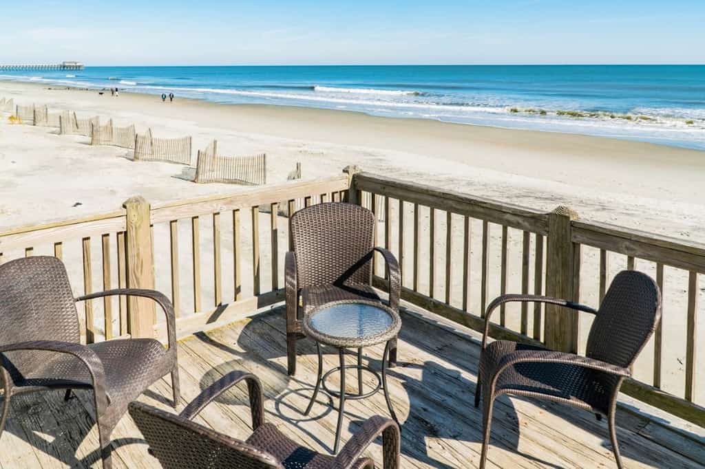 This newly renovated beach house comfortably sleeps 14 guests with 2 king beds, 1 queen bed, 2 sets of triple bunk beds, and a sleeper sofa in the living area!