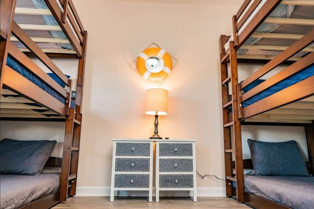 This newly renovated beach house comfortably sleeps 14 guests with 2 king beds, 1 queen bed, 2 sets of triple bunk beds, and a sleeper sofa in the living area!
