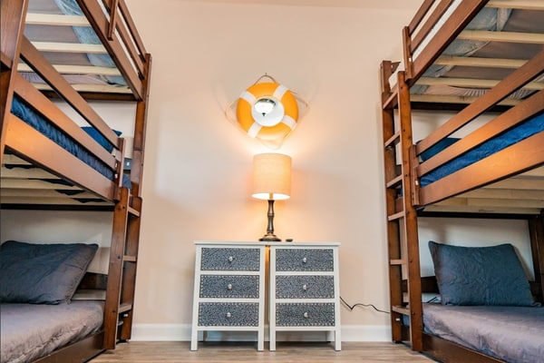 This newly renovated beach house comfortably sleeps 14 guests with 2 king beds, 1 queen bed, 2 sets of triple bunk beds, and a sleeper sofa in the living area!