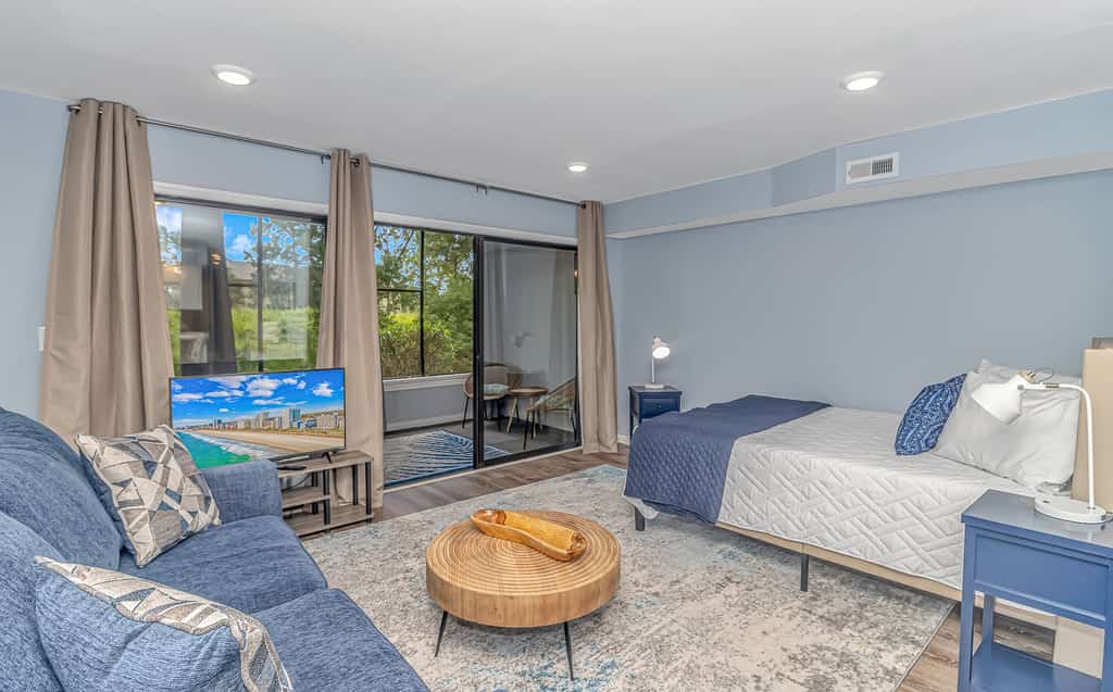 Welcome to this first floor, newly renovated, large efficiency condo at Cypress Bay in Little River, SC, perfect for your next vacation or business trip. This condo has a fully-equipped kitchen, sleeps up to two guests in a queen bed and has a separate office area with desk, and also a large, screened porch overlooking green space for relaxation. Enjoy the portable projector and screen for entertainment or work purposes. There is a community pool and hot tub and parking is free and right in front of the unit. With so many entertainment attractions, dining options and golf courses in the area, there will always be something to do.