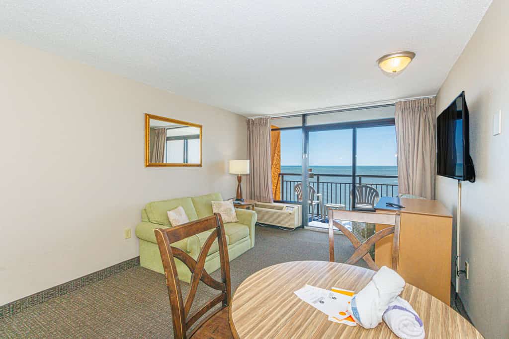 The search for your next vacation stops here! Check out this 15th floor, oceanfront condo at the Landmark Resort in Myrtle Beach. This 1-bedroom suite is fully furnished with 2 full beds, 1 full size murphy bed, and will comfortably accommodate 6 guests. This condo offers a spacious living space with a love seat, TV, a small dining table with chairs, and beautiful oceanfront views from the private balcony right off the living area.