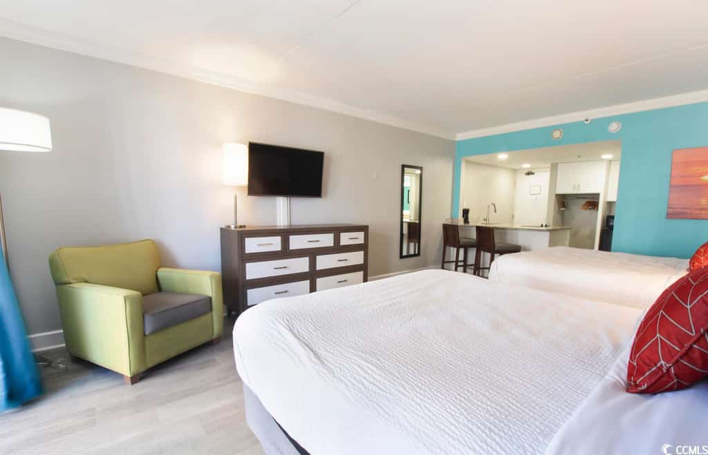 Your dream beach getaway awaits! Discover this updated 2nd-floor ocean-view condo at Grande Cayman Resort in Myrtle Beach, SC. This fully furnished vacation rental features 2 queen-size beds, an accent chair, a wall-mounted cable TV, and a cozy bar area with 2 chairs. Enjoy stunning ocean views from your private balcony, perfect for relaxing after a day of sun and sand. Experience the ultimate coastal retreat in this beautiful condo, just steps from the beach!