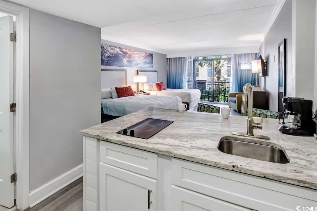 Your dream beach getaway awaits! Discover this updated 2nd-floor ocean-view condo at Grande Cayman Resort in Myrtle Beach, SC. This fully furnished vacation rental features 2 queen-size beds, an accent chair, a wall-mounted cable TV, and a cozy bar area with 2 chairs. Enjoy stunning ocean views from your private balcony, perfect for relaxing after a day of sun and sand. Experience the ultimate coastal retreat in this beautiful condo, just steps from the beach!