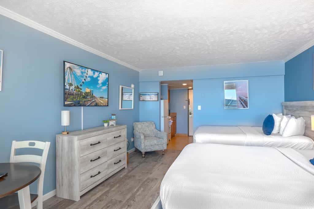 The search for your next unforgettable beach escape ends here. Welcome to this beautifully renovated seventh floor direct oceanfront studio at the Ocean Reef Resort in Myrtle Beach, where the sights and sounds of the Atlantic greet you from the moment you arrive. Bathed in natural light and styled with breezy coastal charm, this inviting space instantly puts you at ease and sets the stage for days filled with sunshine and relaxation. Designed with comfort and ease in mind, the studio features two plush queen sized beds that comfortably accommodate up to four guests while still offering plenty of room to stretch out and unwind.