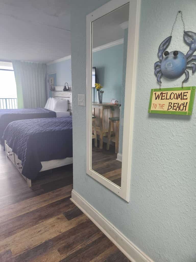 If you're looking for an updated vacation rental that's perfect for up to 5 guests, look no further! Welcome to this gorgeous 9th-floor queen suite at the Sand Dunes Resort in Myrtle Beach, SC. This oceanfront studio is fully furnished with everything you'll need for a comfortable, memorable stay, featuring two cozy queen beds, a twin trundle bed, closet space for storage, a custom-made surfboard dining table with stools, flat-screen TV with basic cable, resort Wi-Fi, private bathroom with a tub/shower combo and vanity, a fridge, kitchen sink, cooktop, and more!