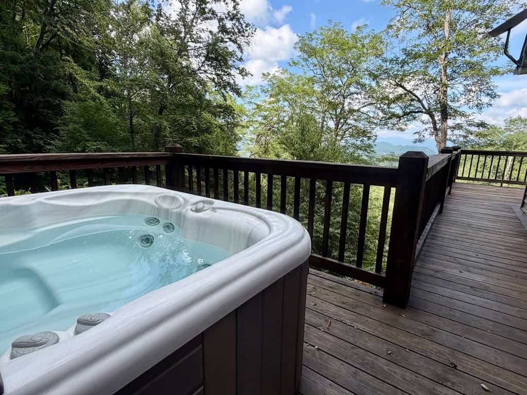 Elevated mountain-view cabin with private hot tub, 2 decks, firepit, & grill