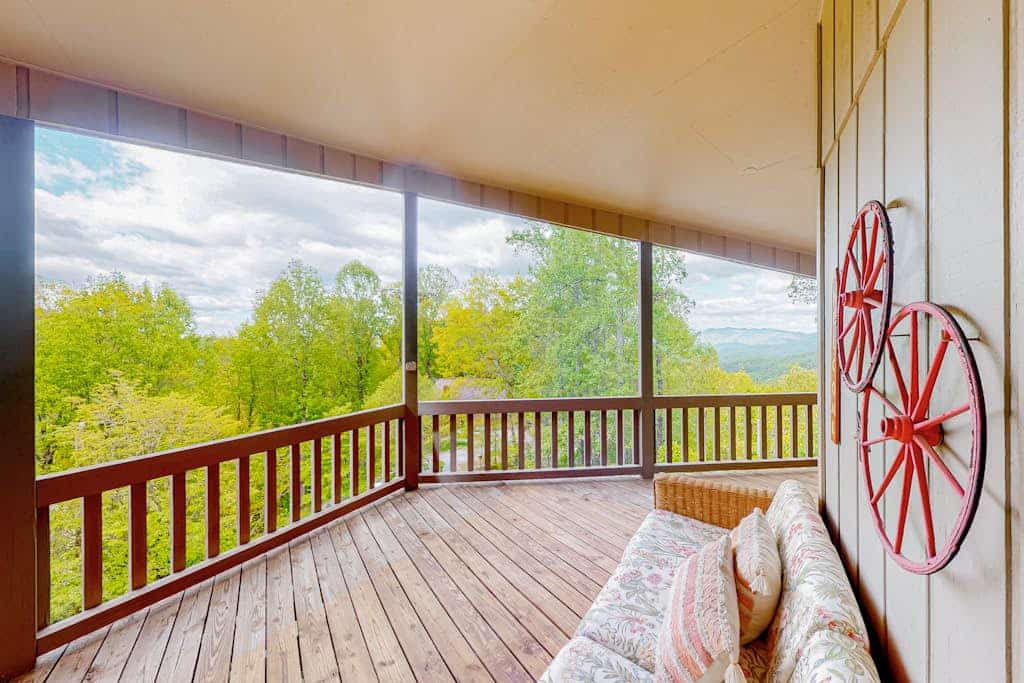 View-worthy home lined by trees with a fireplace, wrap-around deck, grill, & W/D