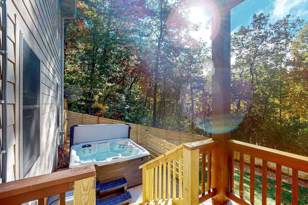 Scenic retreat with private hot tub, fenced yard, fire table, & furnished porch