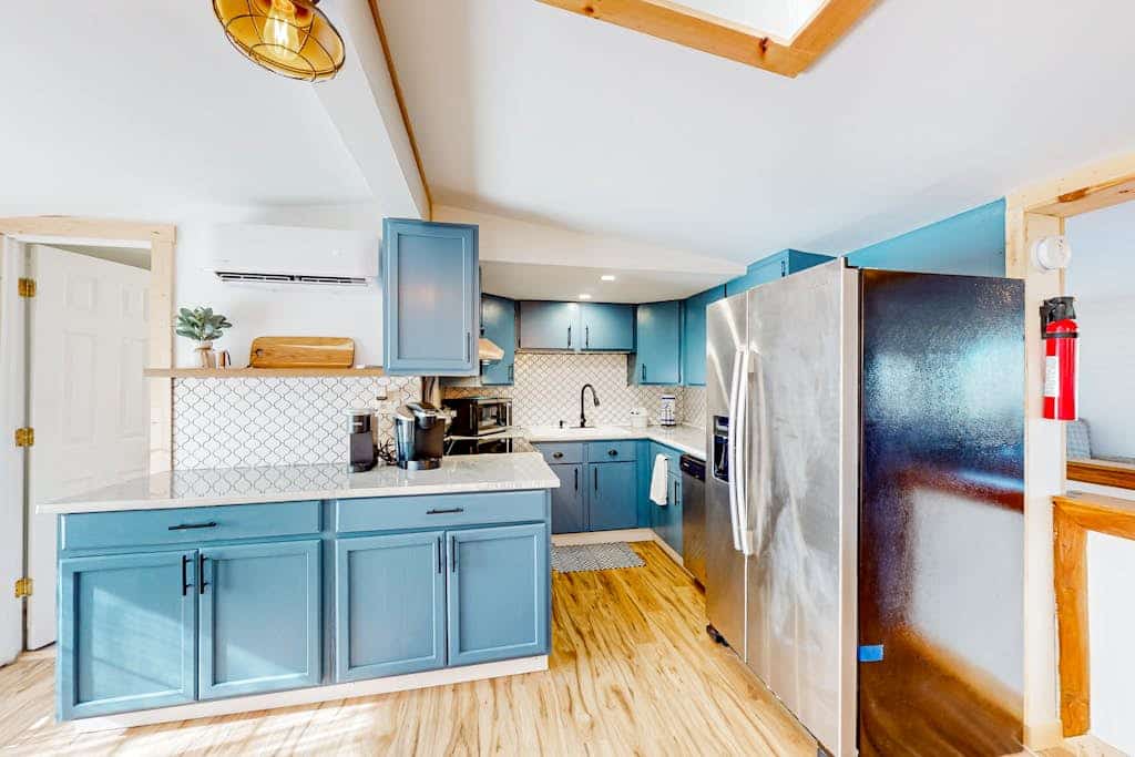 Tree-lined lake view abode with large deck, modern interior, board games, & W/D