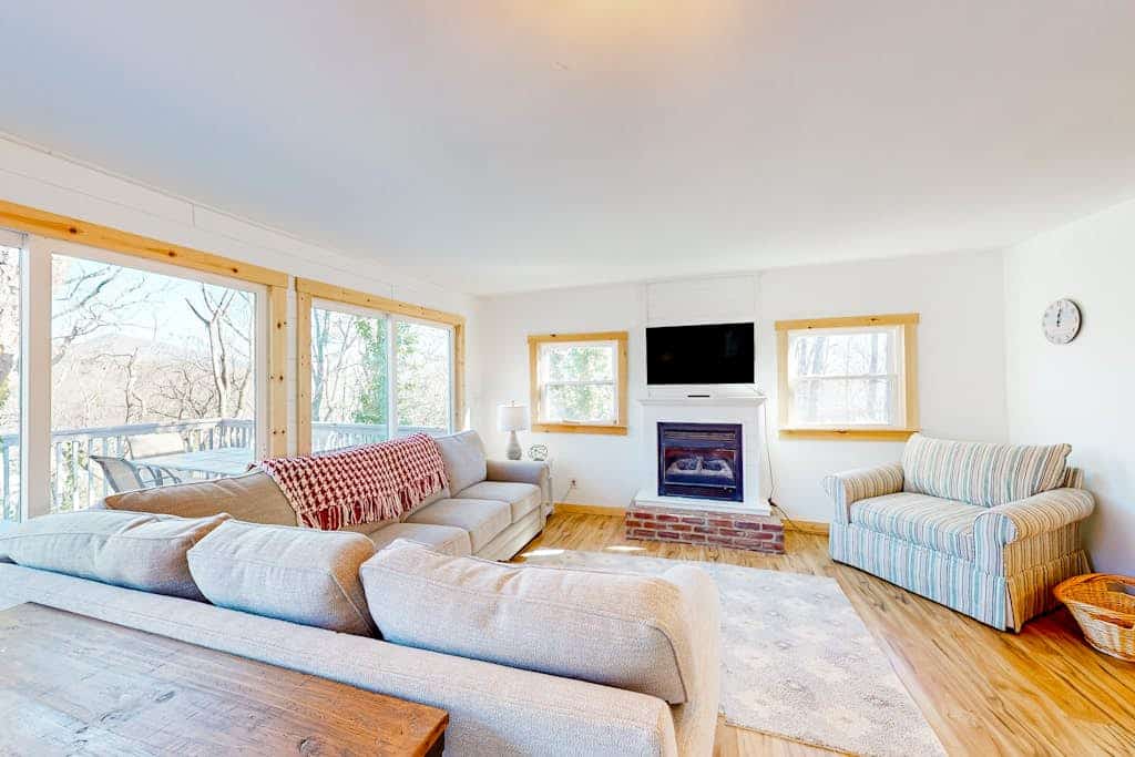 Tree-lined lake view abode with large deck, modern interior, board games, & W/D