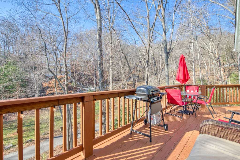Cozy home with wraparound deck, fireplace, AC, & W/D