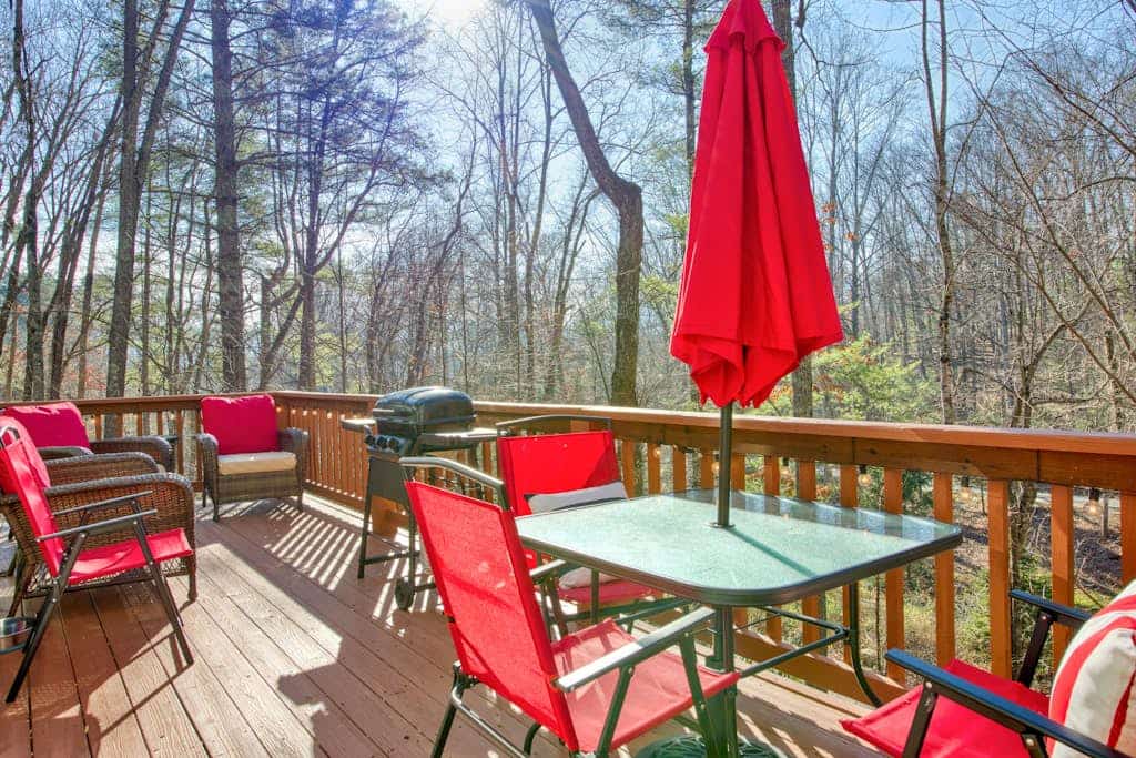 Cozy home with wraparound deck, fireplace, AC, & W/D