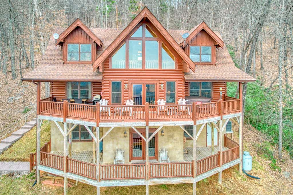 Rustic mountain-view home with deck, fire pit, hot tub, fireplace, & game room