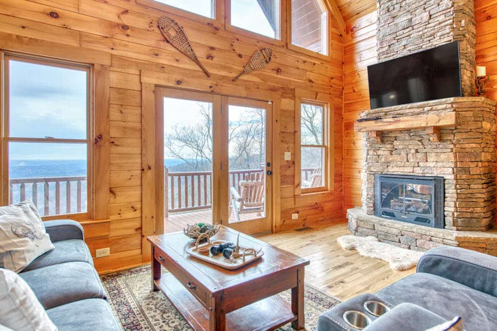 Rustic mountain-view home with deck, fire pit, hot tub, fireplace, & game room