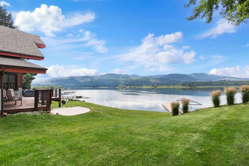 Custom riverfront home with private dock, game room, hot tub & heated floors