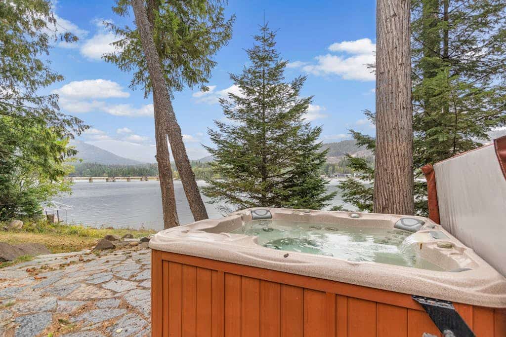 Riverfront home with mountain view, hot tub, deck, WiFi, W/D, & fireplace