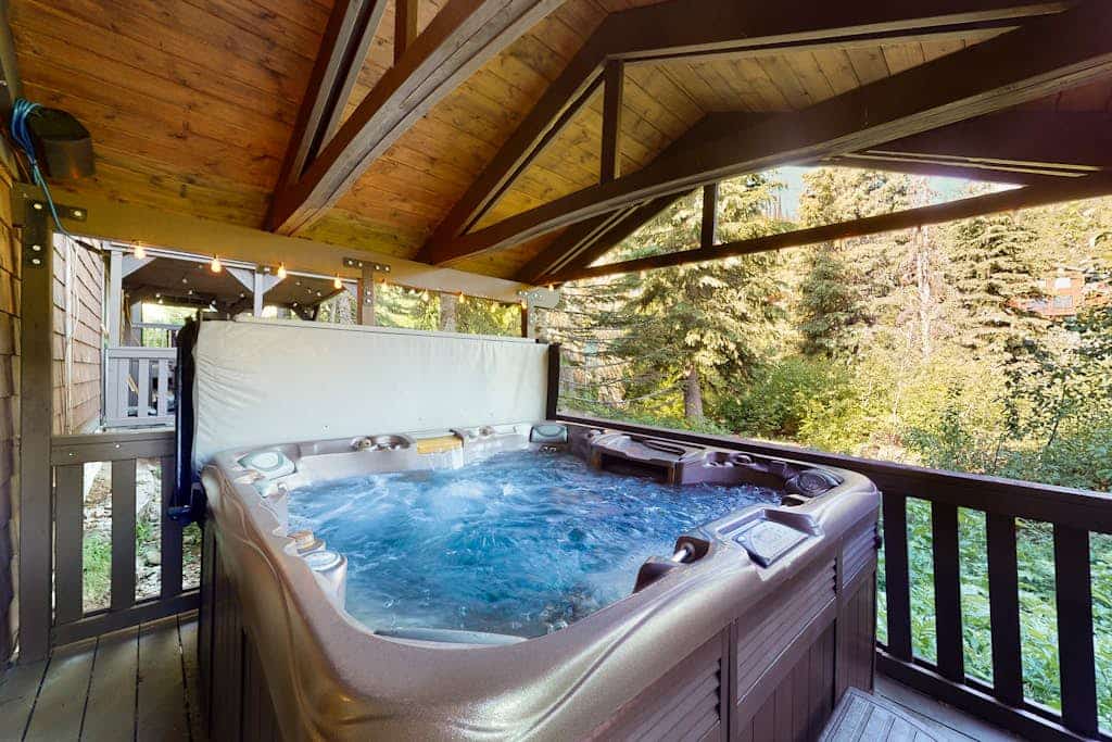 Tranquil condo near shopping with private hot tub, mountain view, deck, & W/D