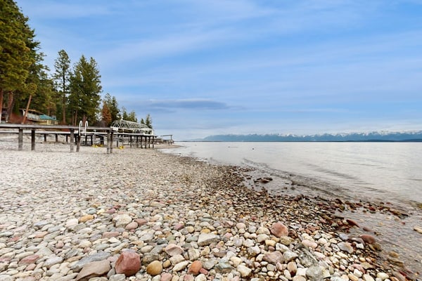 Lakefront home with amazing mountain views, wraparound deck, fireplace, & grill