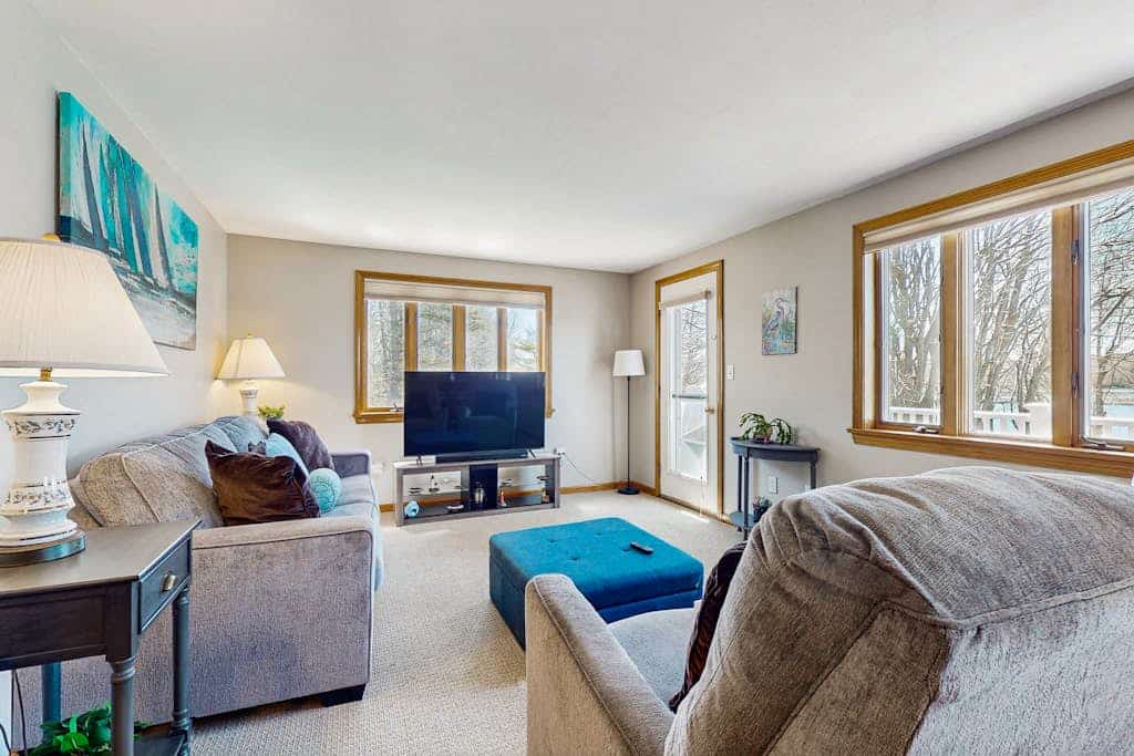 Tranquil waterfront home with stunning views, a spacious deck, and a BBQ grill