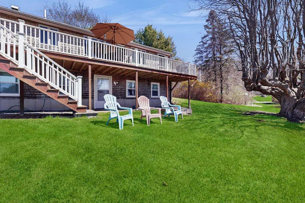 Tranquil waterfront home with stunning views, a spacious deck, and a BBQ grill