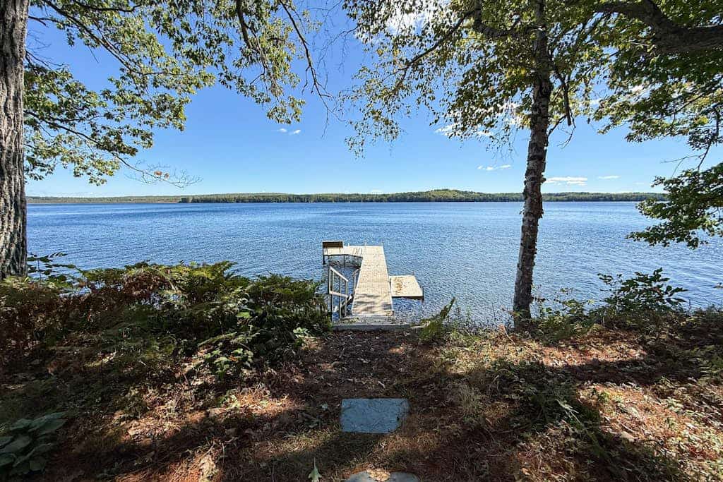 Inviting Lakeside Home with direct dock access, patio seating, and gas fireplace