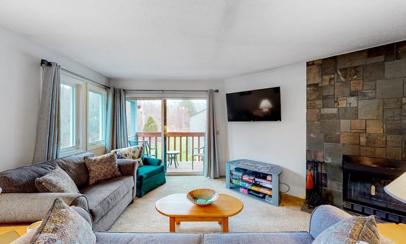 Condo with balcony views, wood-burning fireplace and community pool