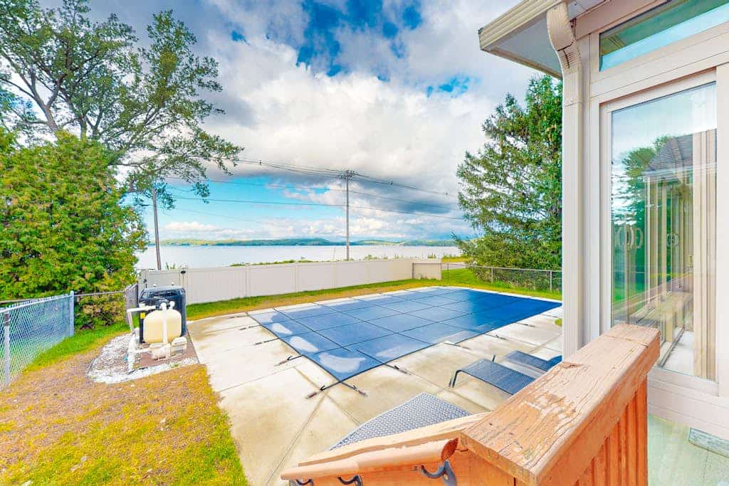 Lakefront home with pool, beach access, central AC, washer/dryer, & fireplace