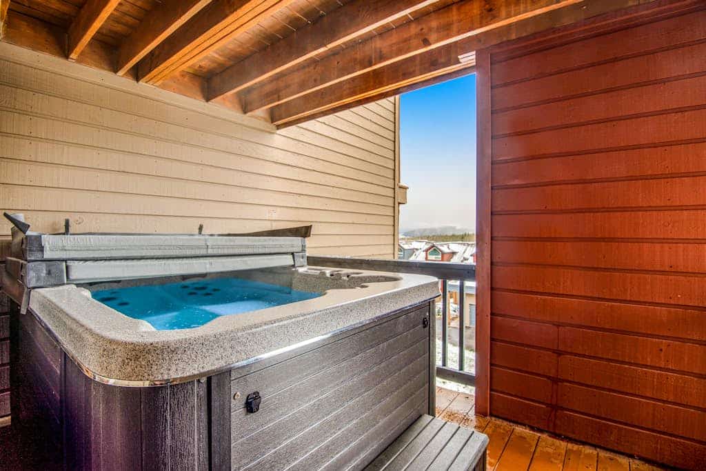 Home with hot tub, gas fireplace, and garage