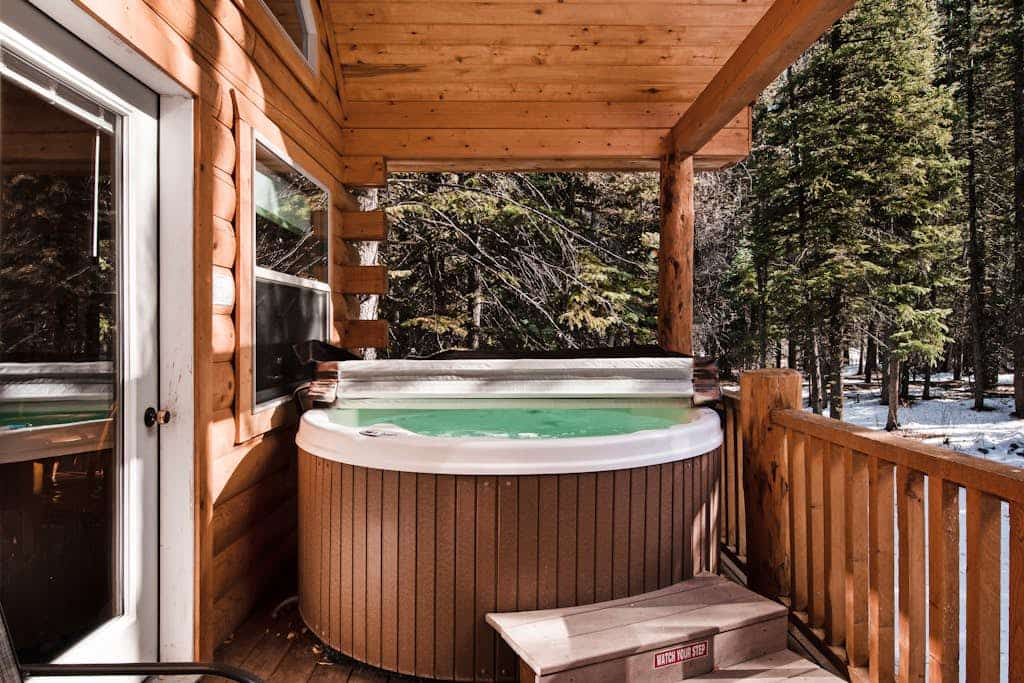 Waterfront cabin with bridge, private hot tub, & WiFi - near National Forest