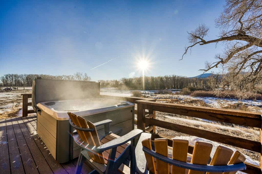 Dog-friendly riverfront retreat with hot tub, stunning views & screened porch