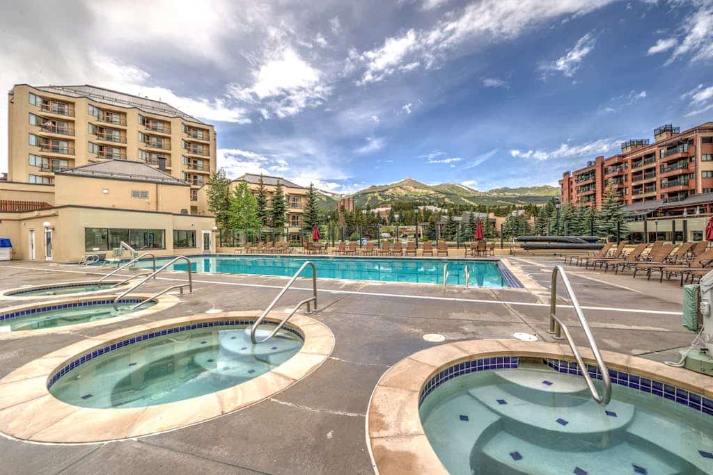 Condo with outdoor pool, hot tubs, gym & fireplace - walk to Peak 9 lifts