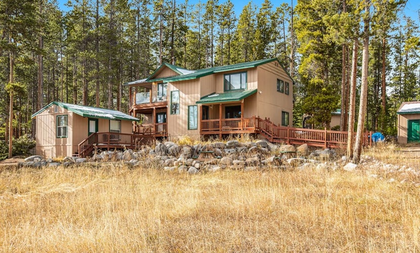 Tree-lined retreat with a wood stove, patio, & studio cottage with a kitchenette
