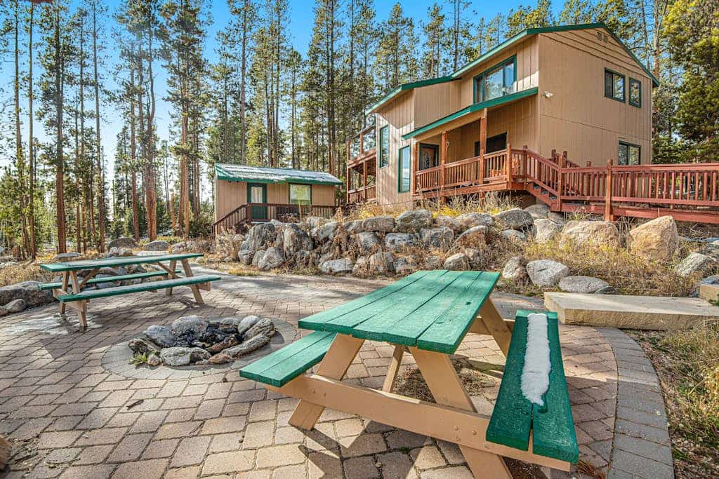 Tree-lined retreat with a wood stove, patio, & studio cottage with a kitchenette