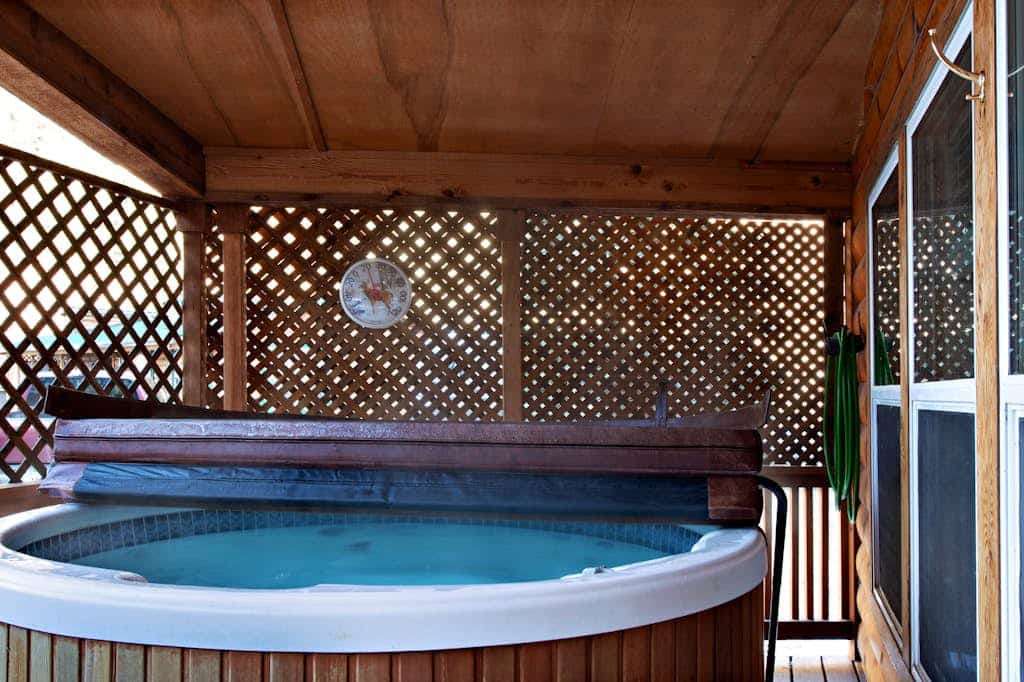 Waterfront cabin with private hot tub, furnished deck, wood stove, & free WiFi