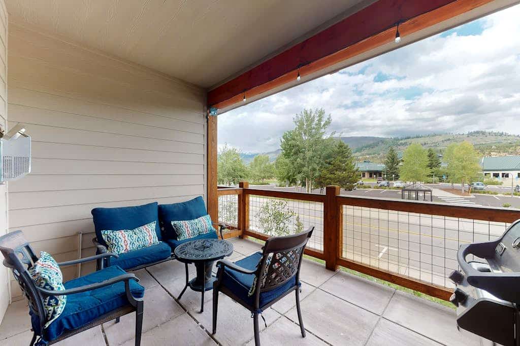 Sunny riverfront getaway with mountain views, private hot tub, & large patio