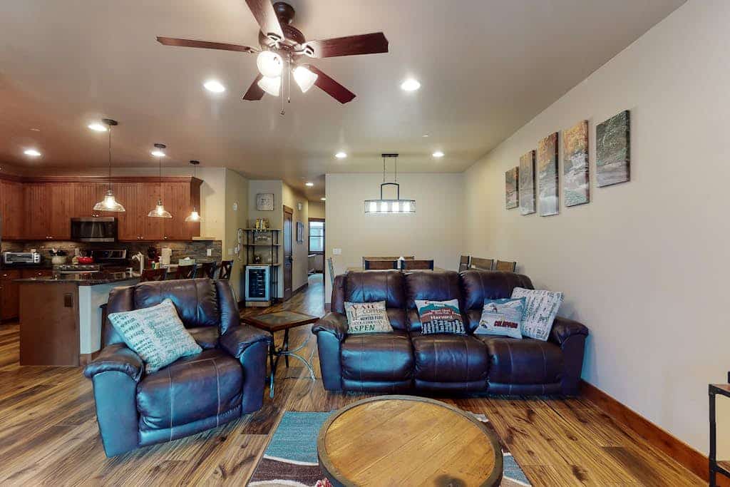 Sunny riverfront getaway with mountain views, private hot tub, & large patio