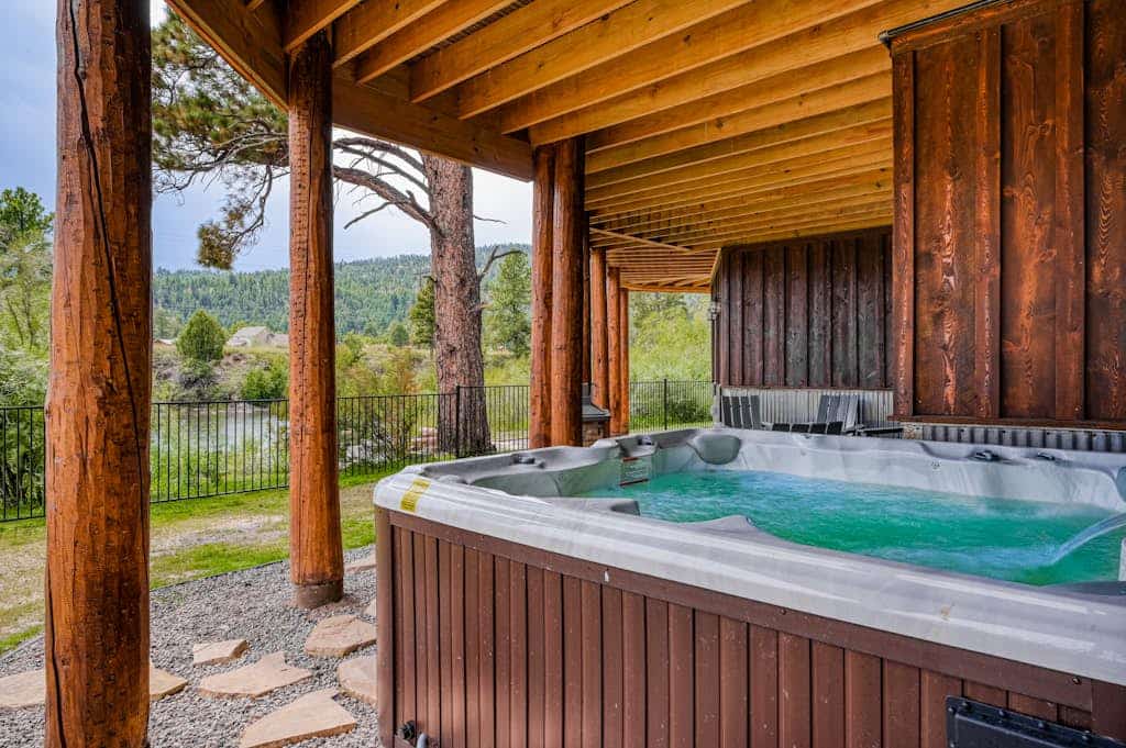 Custom riverfront log home w/ hot tub, decks & fireplace