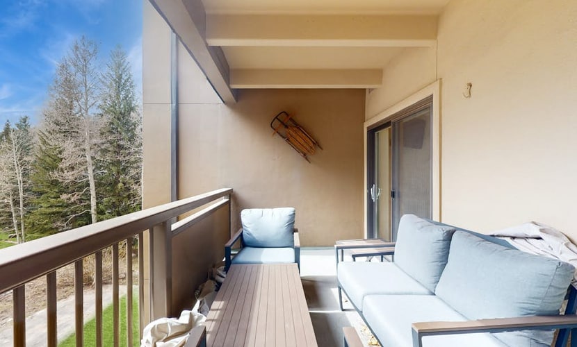 Mountain view condo with large balcony, pool & hot tub - steps to ski shuttle